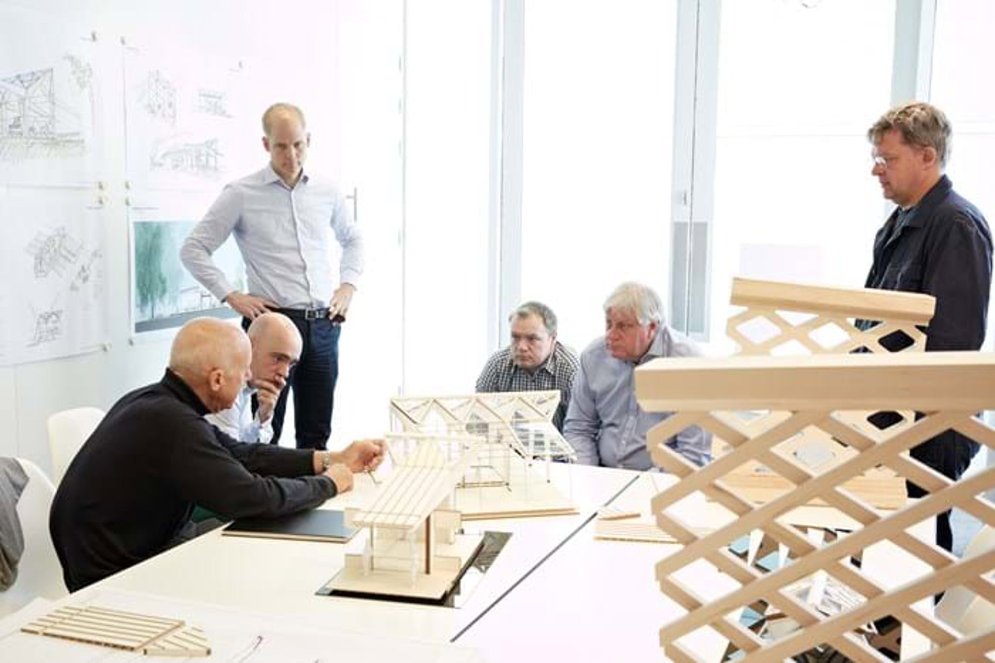 Architects and structural engineers discuss the developing design of Maggie’s Manchester. From left to right: Norman Foster, Diego Alejandro Teixeira Seisdedos, Roger Ridsdill Smith, Darron Haylock, David Nelson, Stefan Behling. © Aaron Hargreaves / Foster + Partners